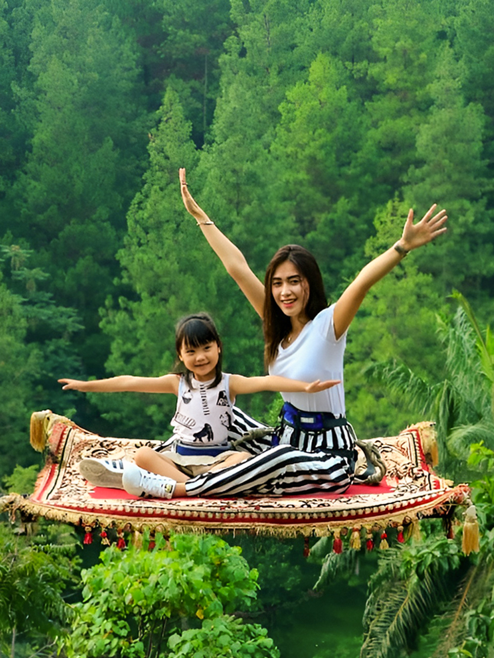 Magic carpet ride experience at Dago Dreampark, Jakarta, Indonesia, with lush forest backdrop.