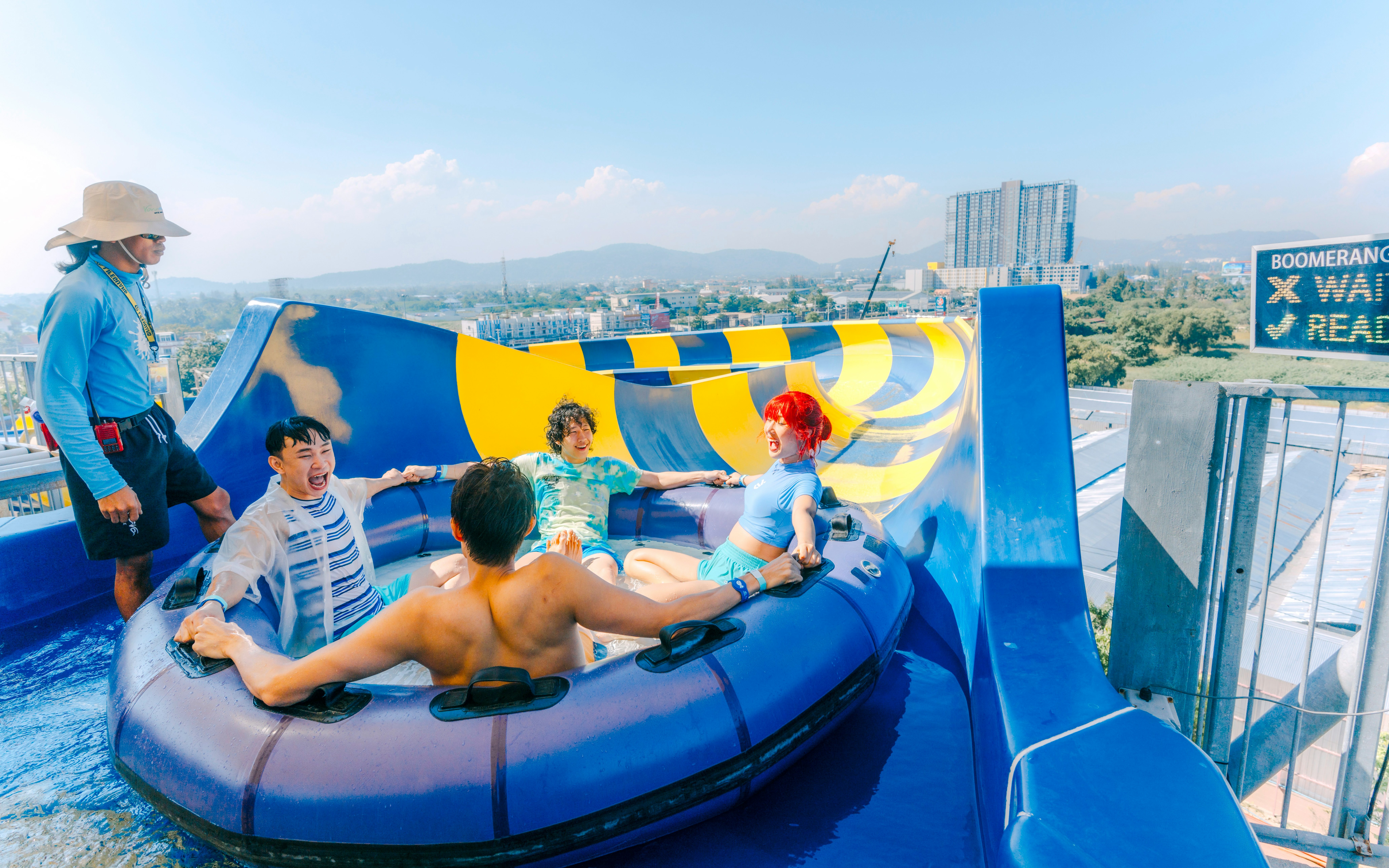 Group enjoying a raft ride on the Boomerang slide at Vana Nava Water Jungle, Hua Hin.