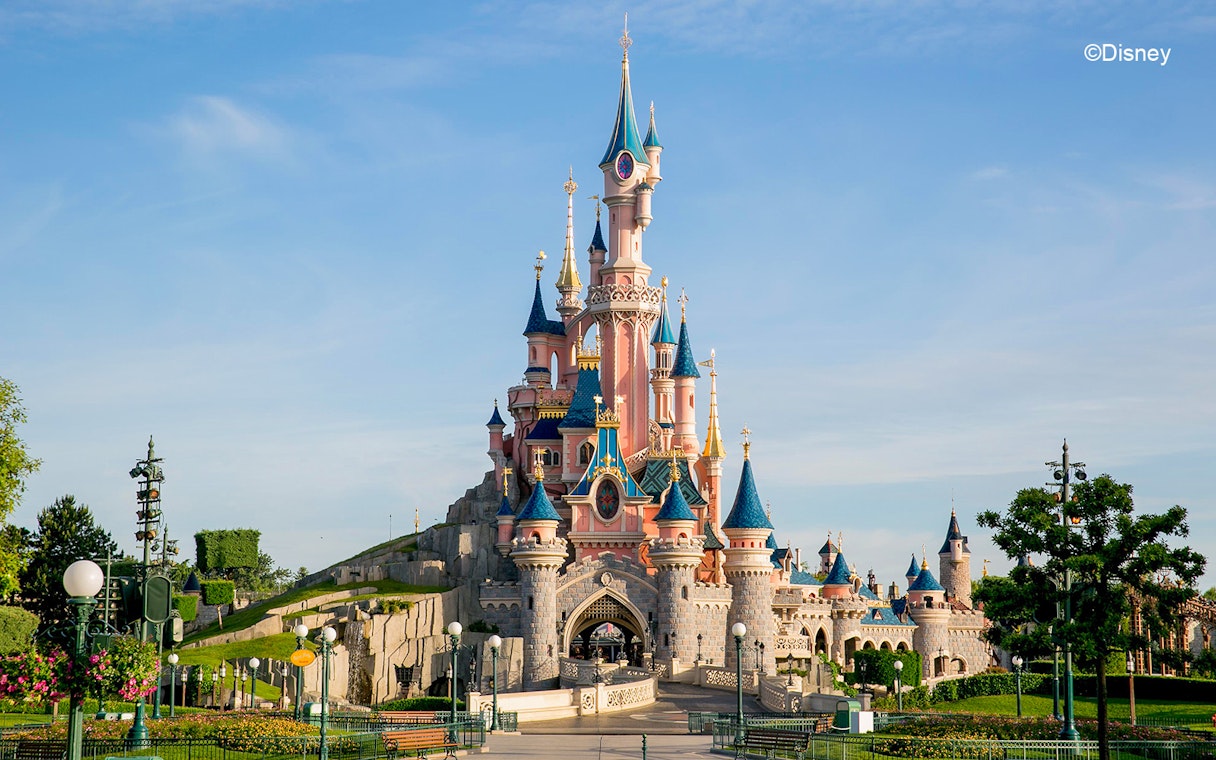 Sleeping Beauty Castle at Disneyland Paris with clear blue sky.