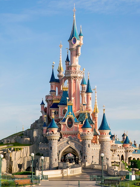 Sleeping Beauty Castle at Disneyland Paris with clear blue sky.