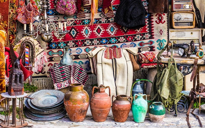 Kruja flea market with traditional Albanian crafts, pottery, and textiles displayed.