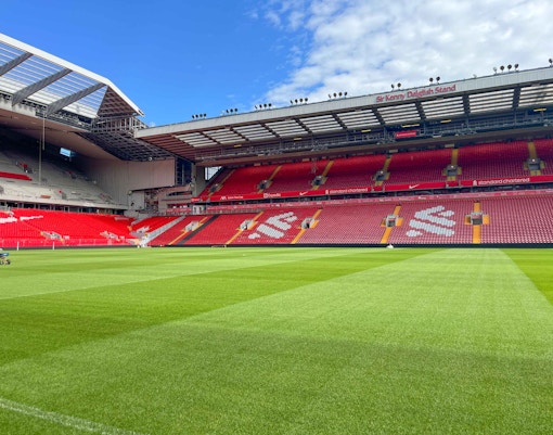 Liverpool FC stadium tour showcasing Anfield's iconic pitch and stands.