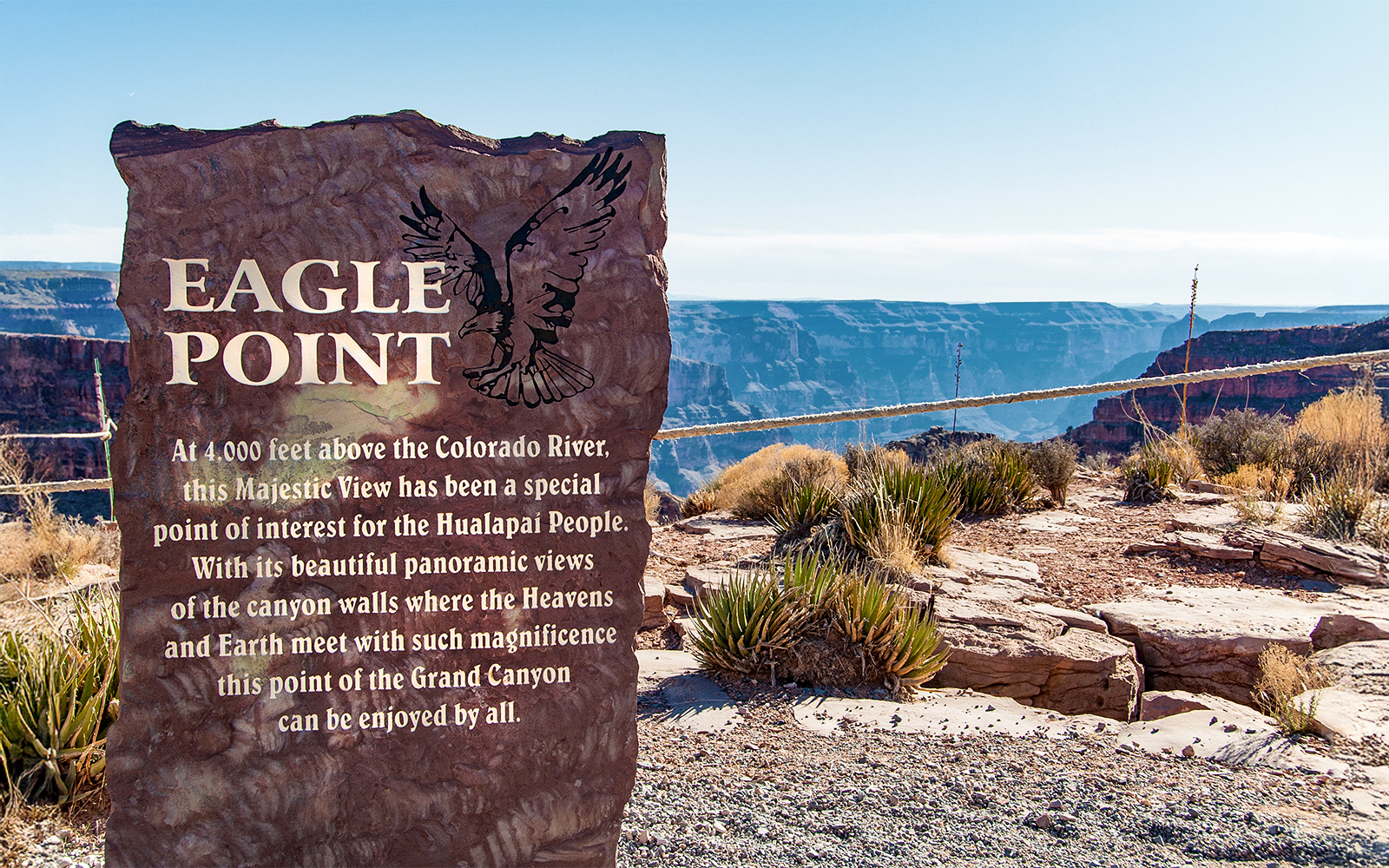 Eagle Point sign with Grand Canyon view in the background, highlighting Hualapai cultural significance.