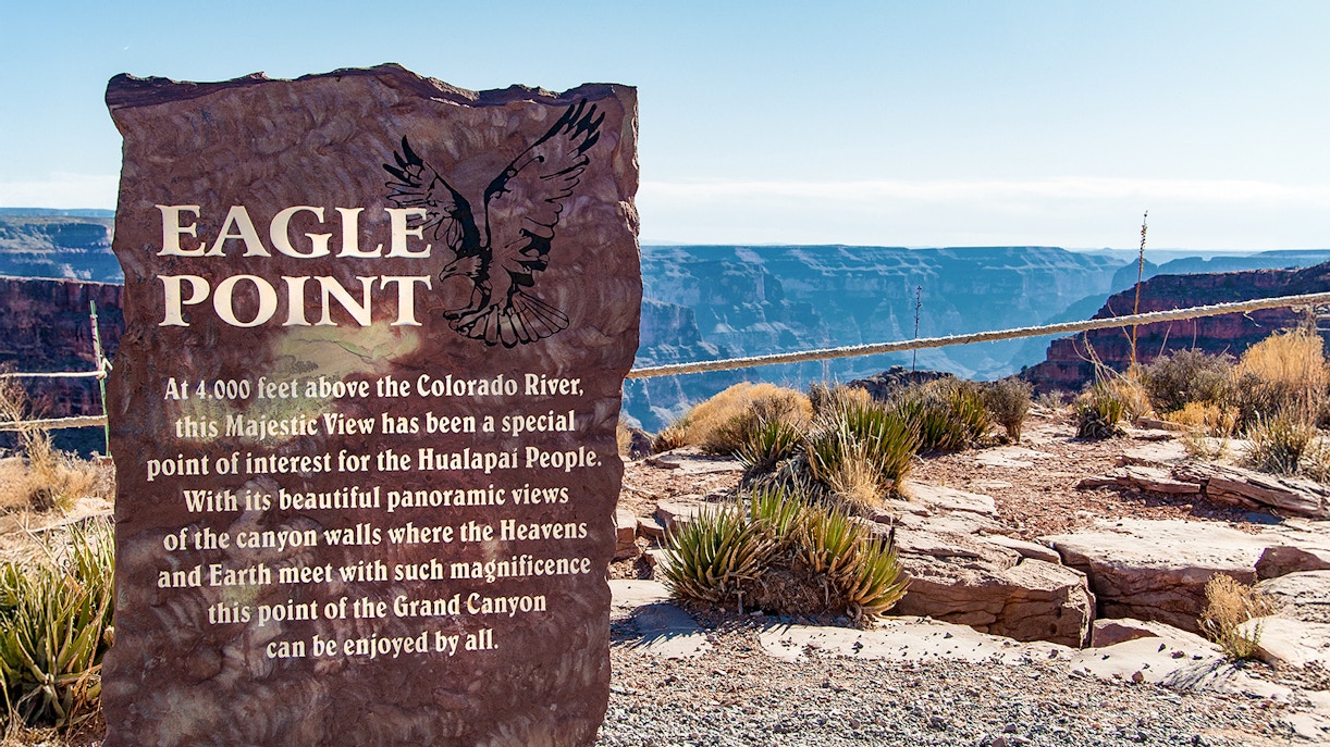 Eagle Point sign with Grand Canyon view in the background, highlighting Hualapai cultural significance.