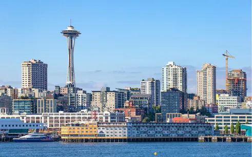 Seattle skyline with Space Needle and waterfront buildings.