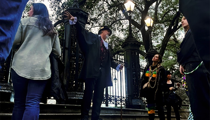 Tour guide leading a group on the New Orleans Haunted Ghost, Voodoo & Vampire Tour.