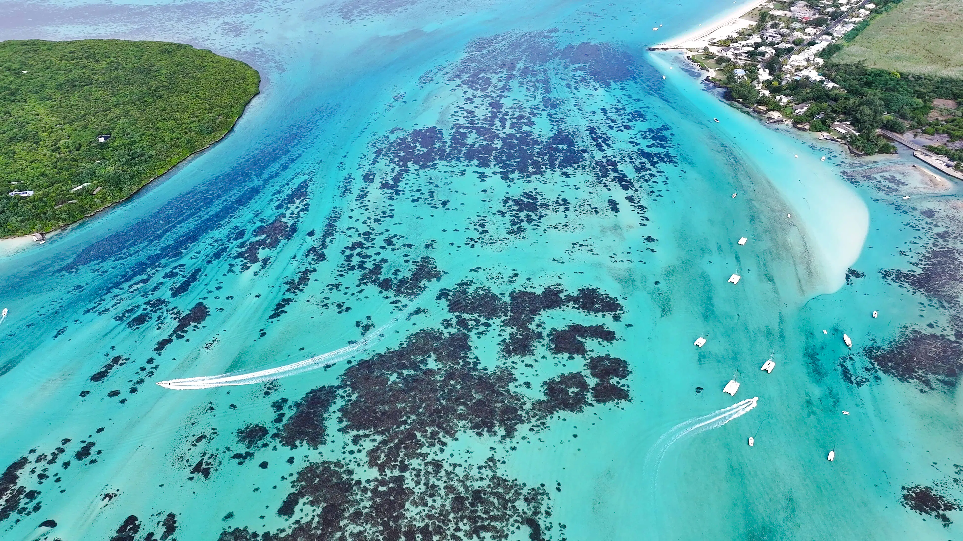 Aerial view of Mahebourg lagoon with boats and coral reefs, Mauritius.