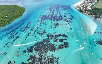 Aerial view of Mahebourg lagoon with boats and coral reefs, Mauritius.