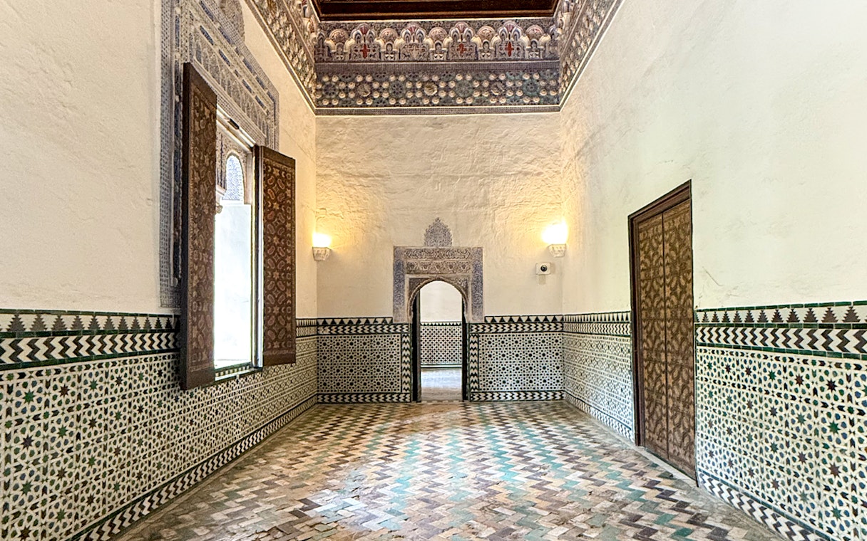 Corridor with intricate tile patterns inside Alcazar, Seville.