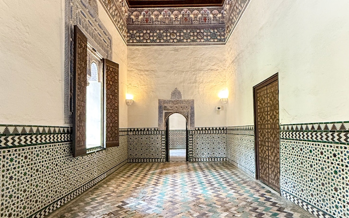 Corridor with intricate tile patterns inside Alcazar, Seville.