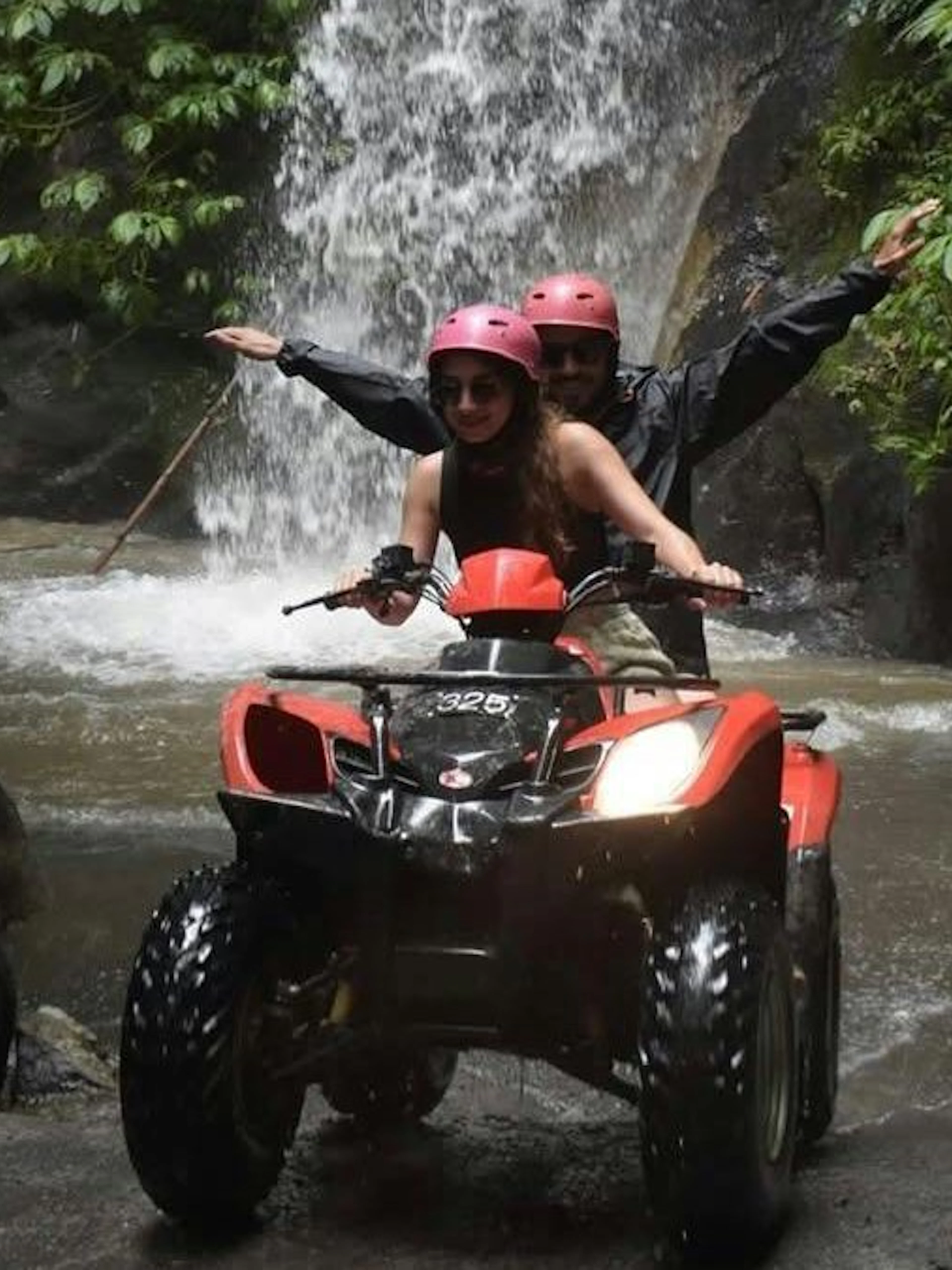 ATV ride through waterfall tunnel on Kuber tour, Bali.