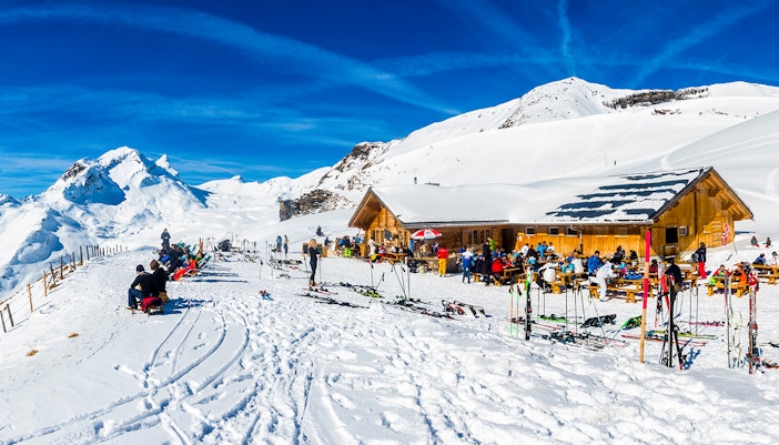 Hikers on a trail with panoramic views of the Swiss Alps at Oberjoch Grindelwald First.