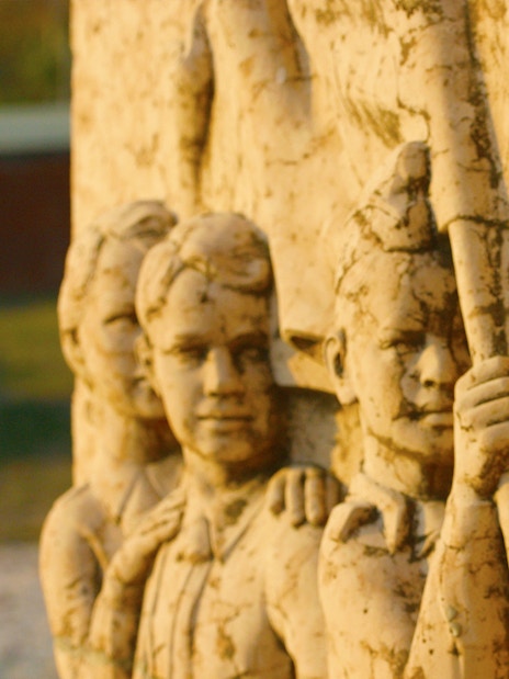 Stone relief of soldiers with a bugler at Memento Park, Budapest.