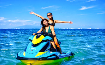 Jet skiing adventure in Tanjung Benoa, Bali with two people enjoying the ocean.