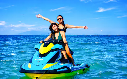 Jet skiing adventure in Tanjung Benoa, Bali with two people enjoying the ocean.