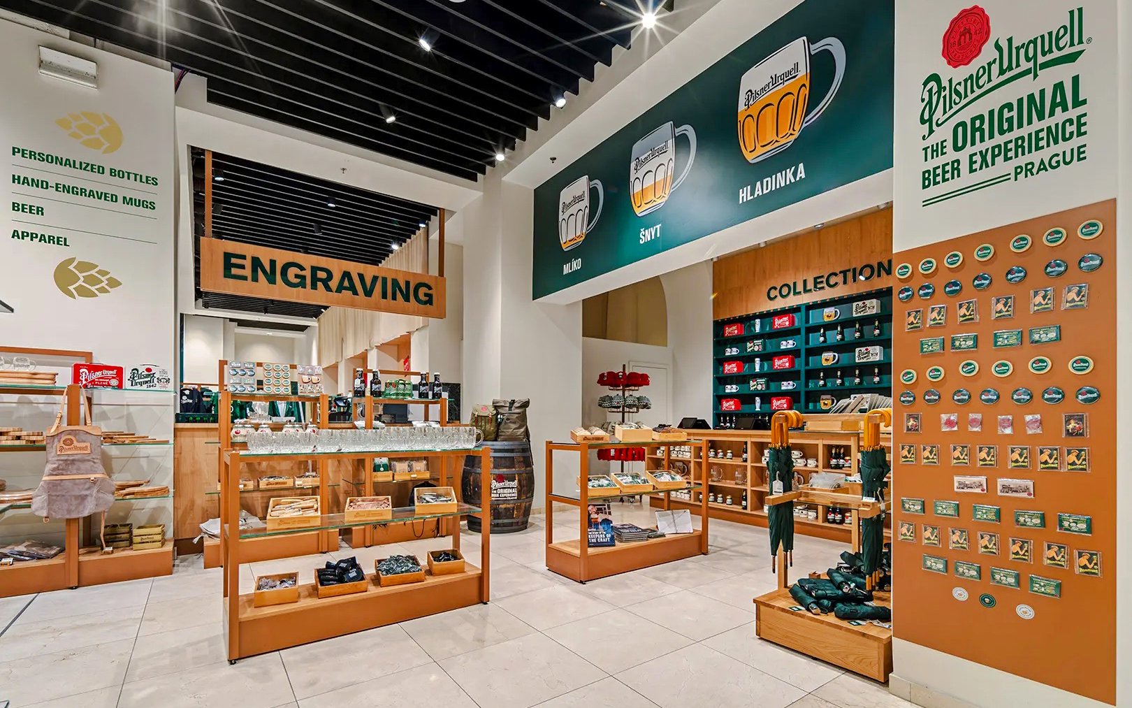 Prague Pilsner Urquell Experience shop with engraved mugs and beer merchandise.
