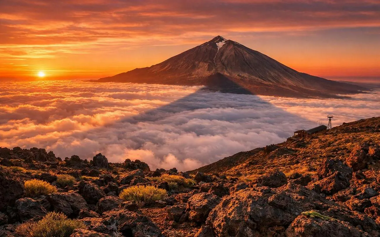 Sunset view of Teide National Park with clouds and mountain peak, Tenerife.