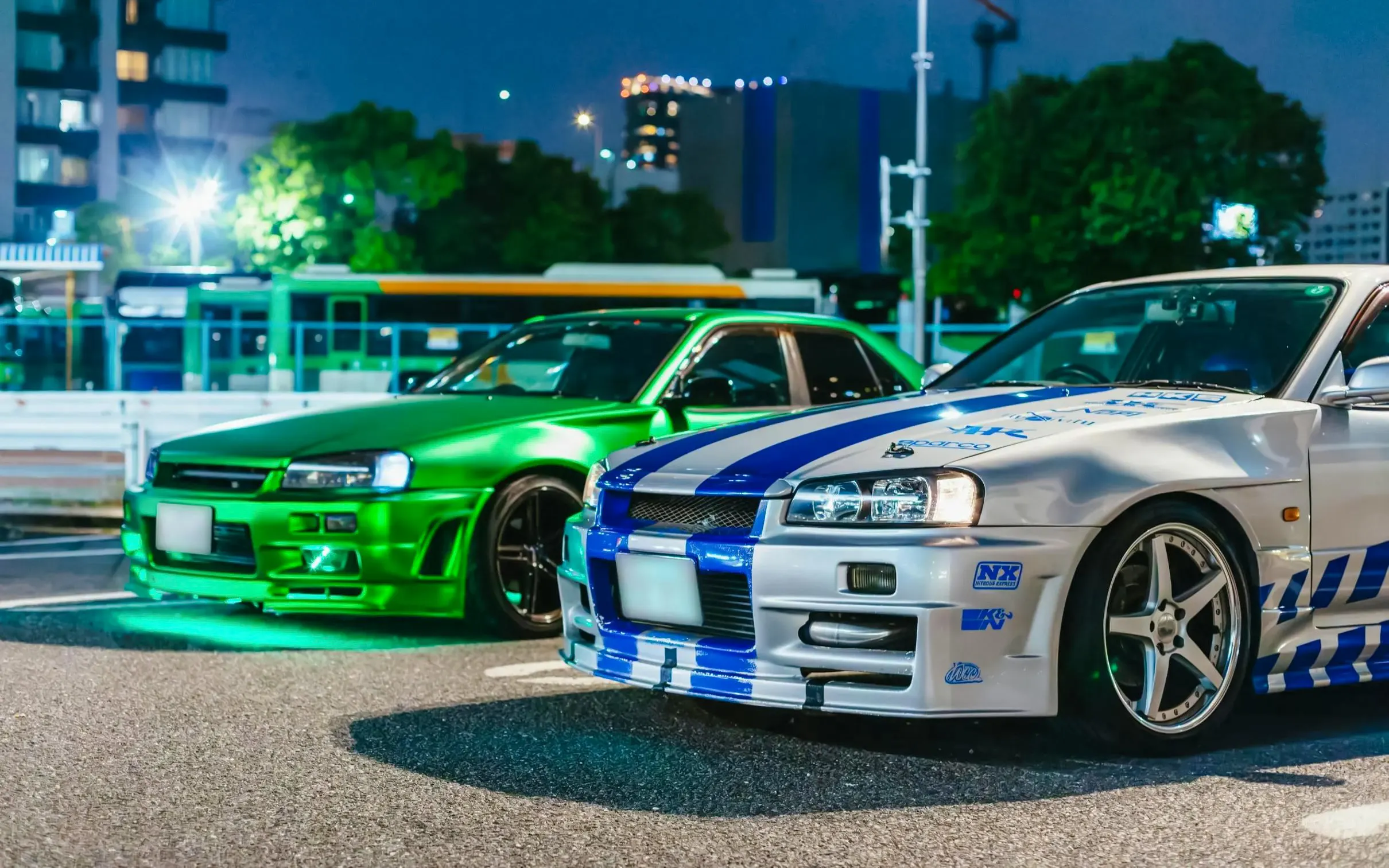 Two modified cars parked in Tokyo at night for the Fast & Furious Tokyo Drift III Experience.