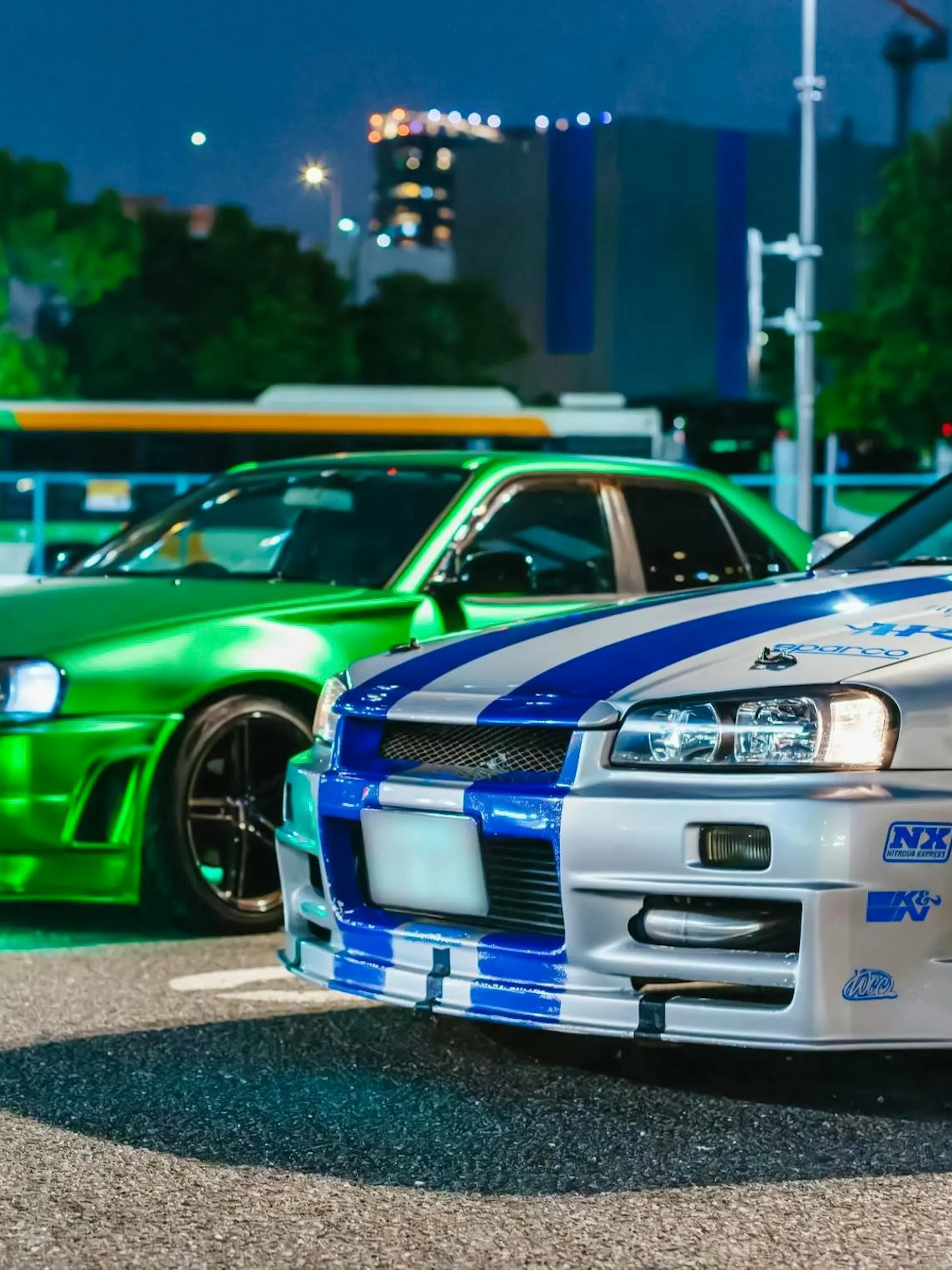 Two modified cars parked in Tokyo at night for the Fast & Furious Tokyo Drift III Experience.