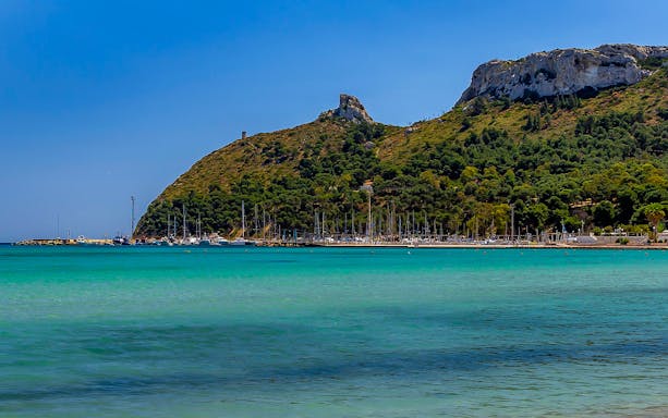 Devil’s Saddle hike view with turquoise sea and marina in Cagliari, Sardinia.