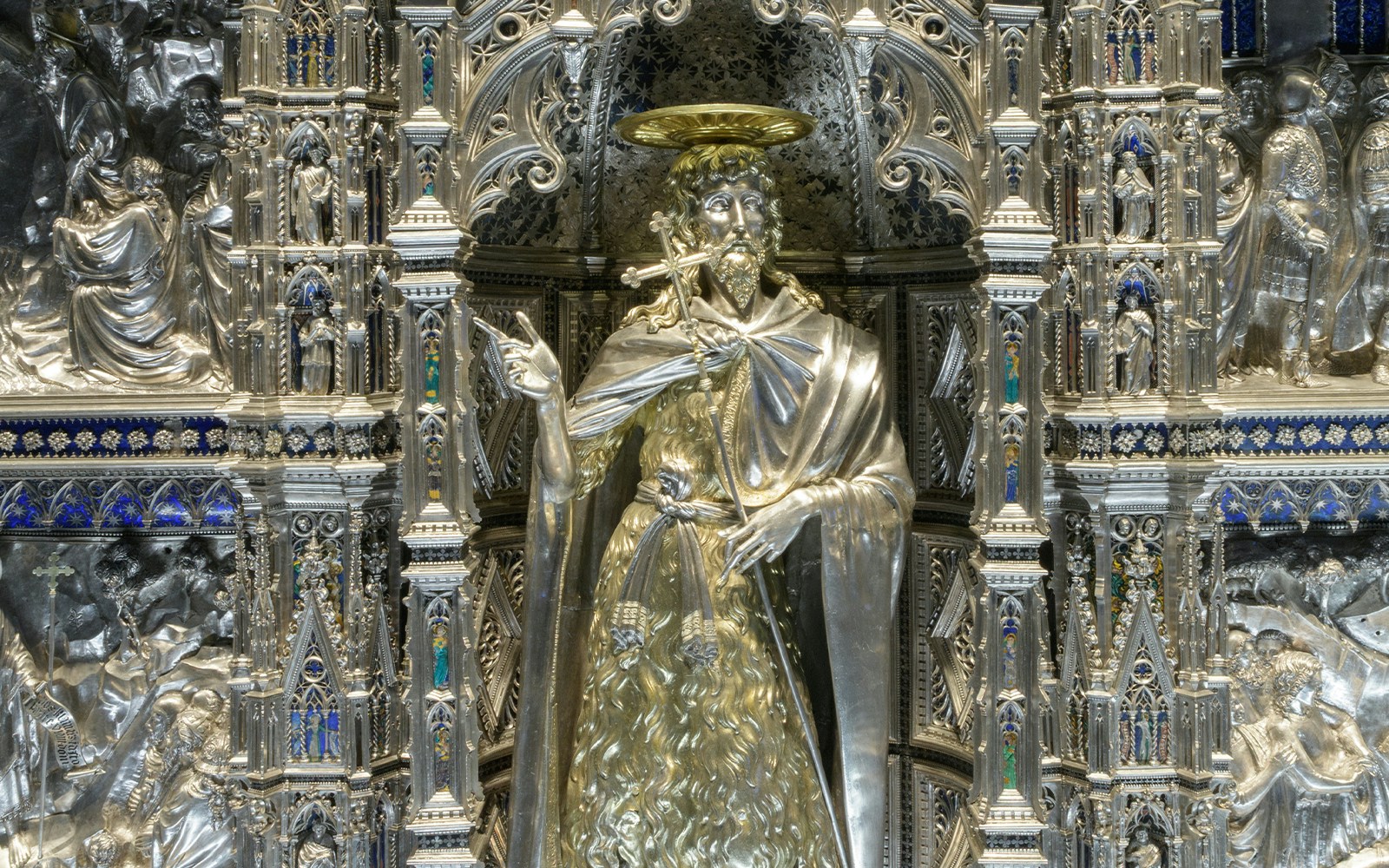 Alt text: "Detail of Saint John sculpture on Altare Argenteo di San Giovanni, Museo dell'Opera del Duomo.