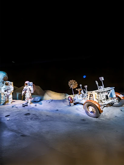 Astronauts and lunar rover exhibit at Houston Space Center.