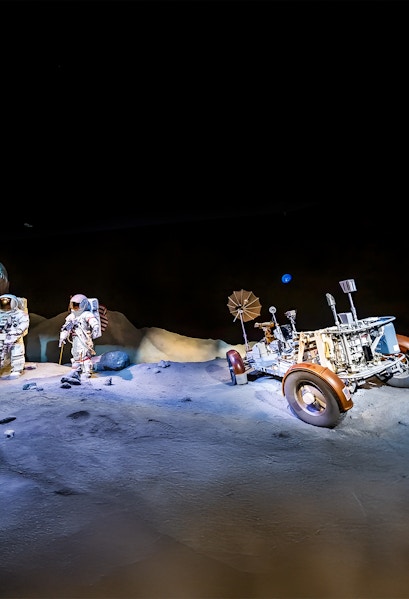 Astronauts and lunar rover exhibit at Houston Space Center.