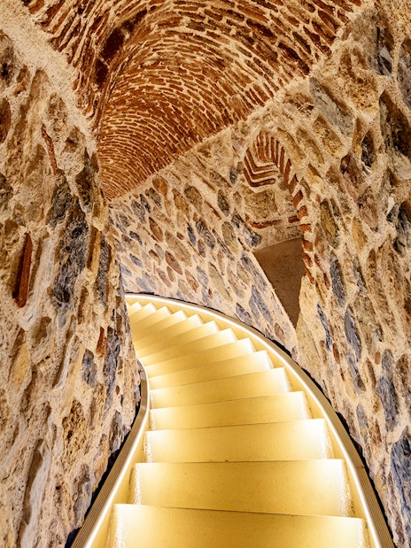 Staircase inside Galata Tower with stone walls and arched ceiling, Istanbul.