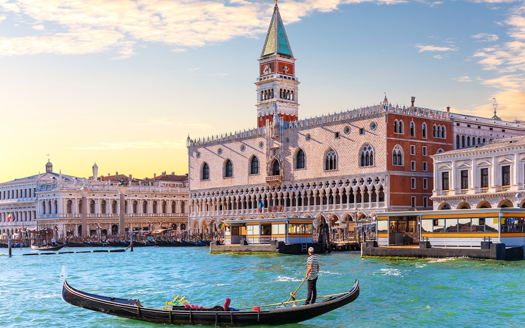 Gondola on Grand Canal with Doge's Palace in Venice, Italy.
