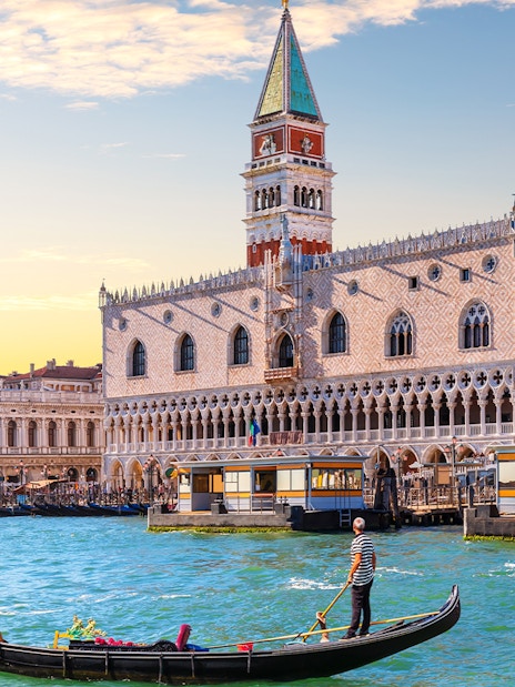 Gondola on Grand Canal with Doge's Palace in Venice, Italy.