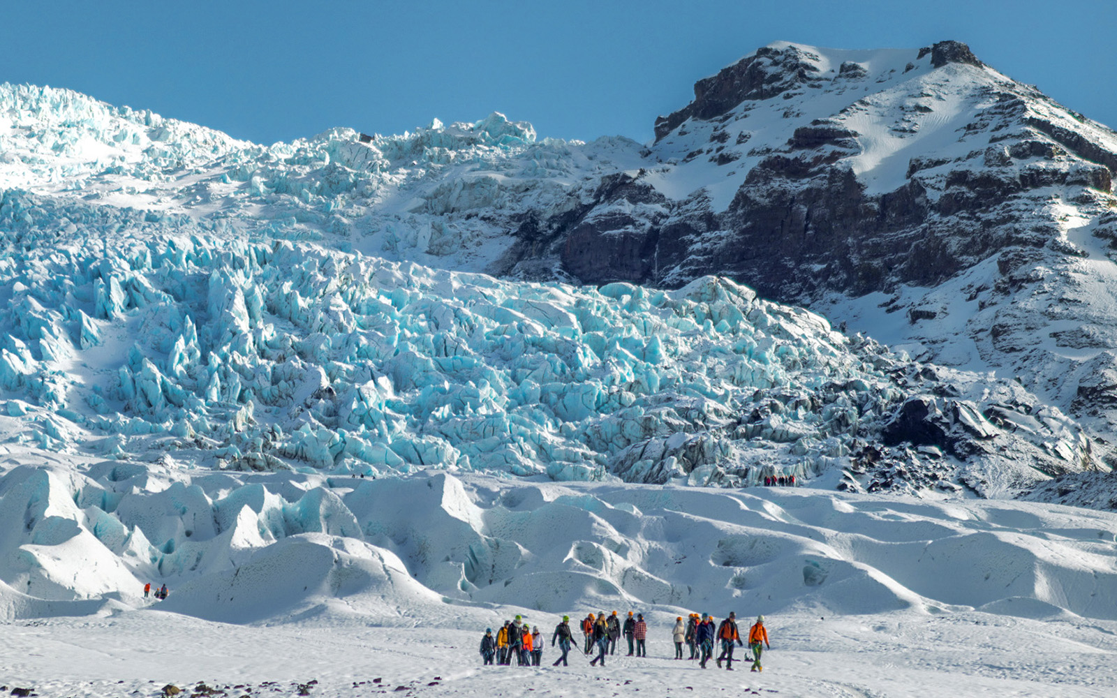 Group of people on a glacier expedition at Vatnajökull, Iceland.