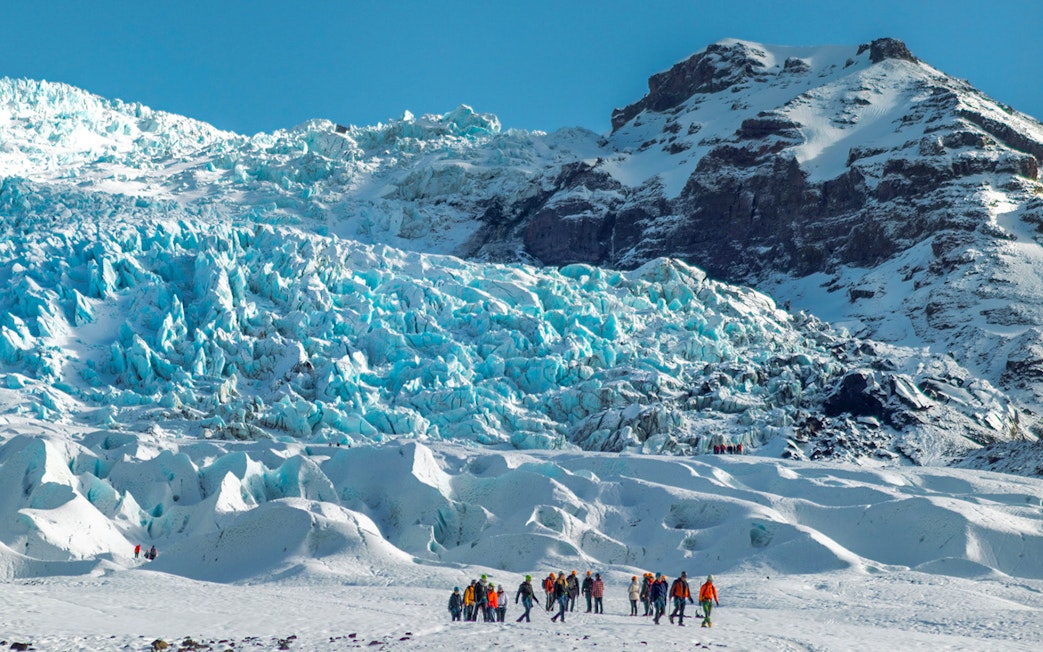 Group of people on a glacier expedition at Vatnajökull, Iceland.