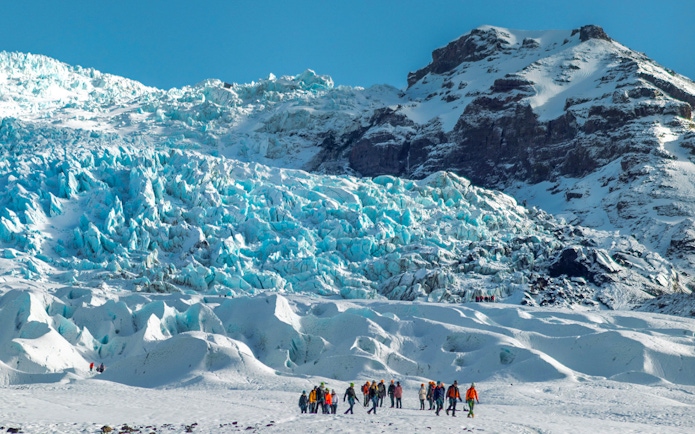 Group of people on a glacier expedition at Vatnajökull, Iceland.