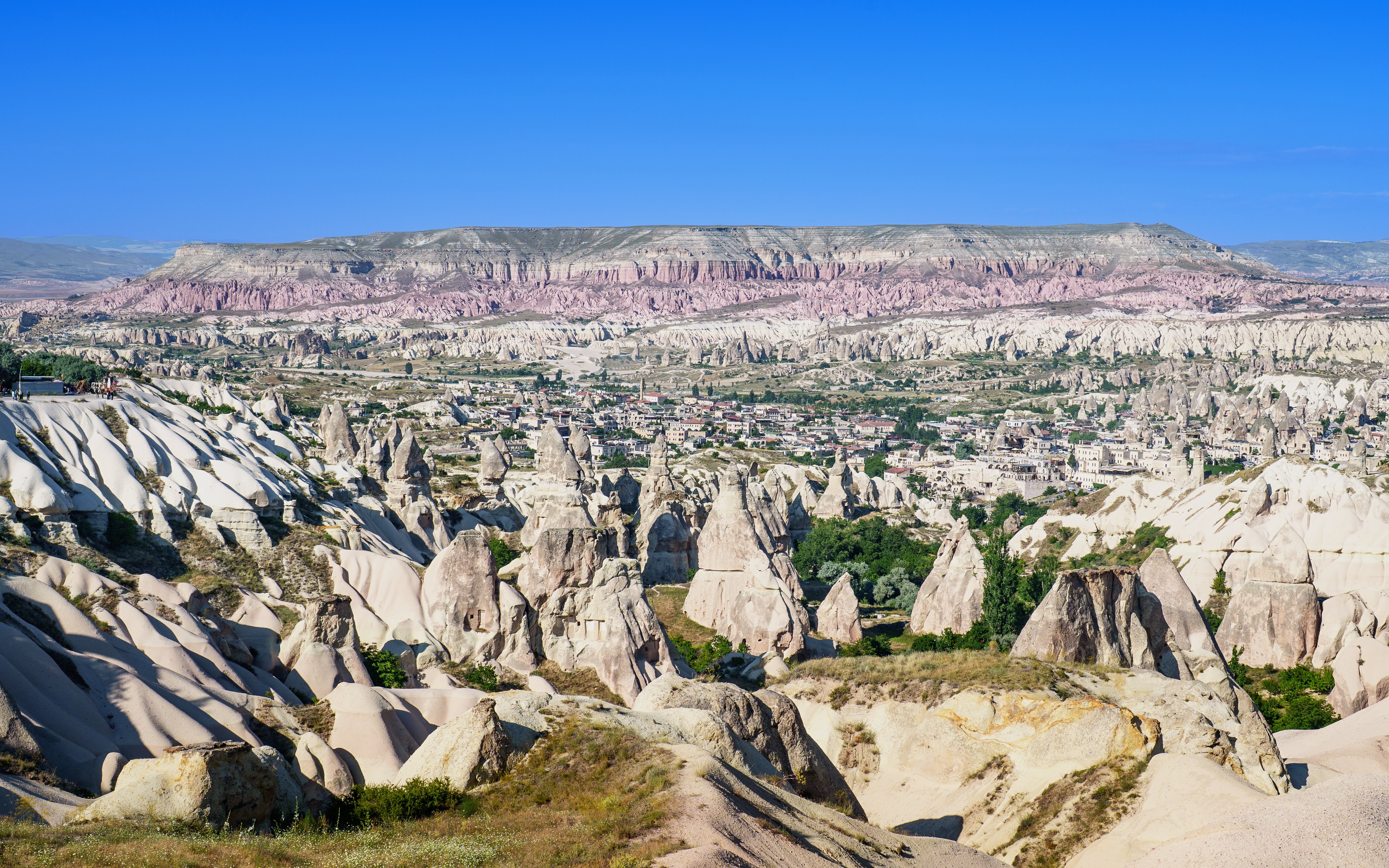 Panoramic view of rock formations and town in Goreme Historical National Park, Turkey.