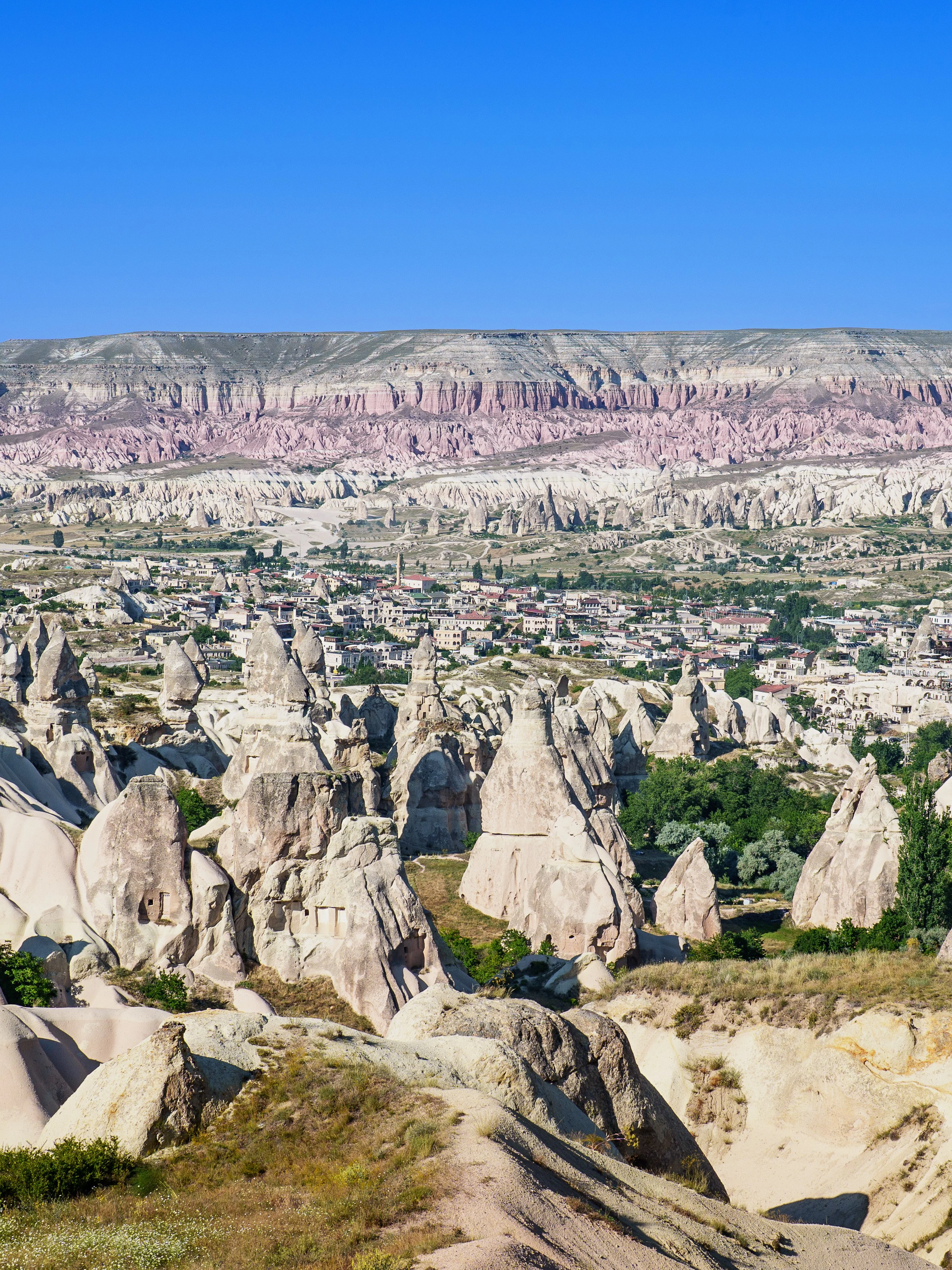 Panoramic view of rock formations and town in Goreme Historical National Park, Turkey.
