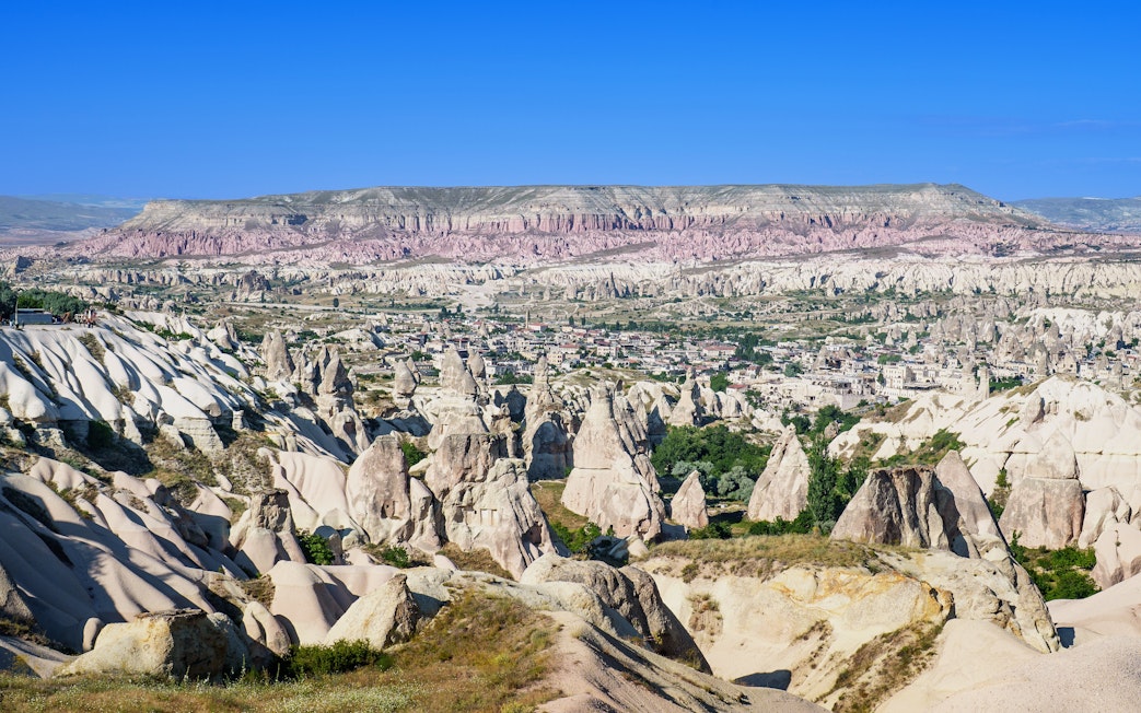 Panoramic view of rock formations and town in Goreme Historical National Park, Turkey.
