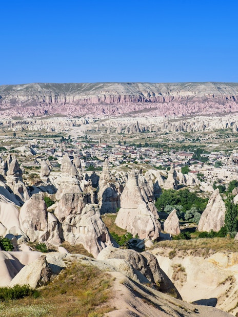 Panoramic view of rock formations and town in Goreme Historical National Park, Turkey.