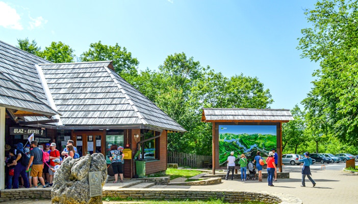 Plitvice Lakes National Park Entrance 1 with cascading waterfalls and lush greenery.