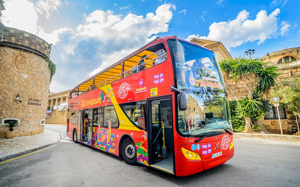 City sightseeing hop-on hop-off bus in front of Pueblo Español, Mallorca.