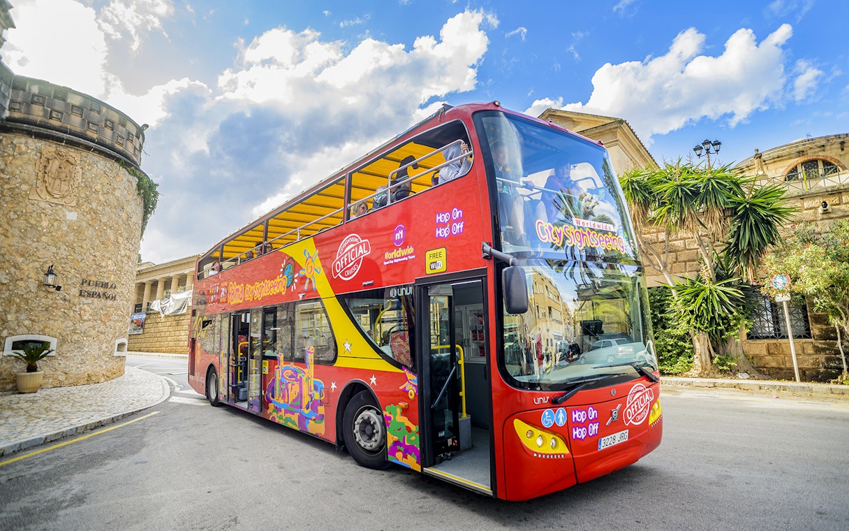 City sightseeing hop-on hop-off bus in front of Pueblo Español, Mallorca.