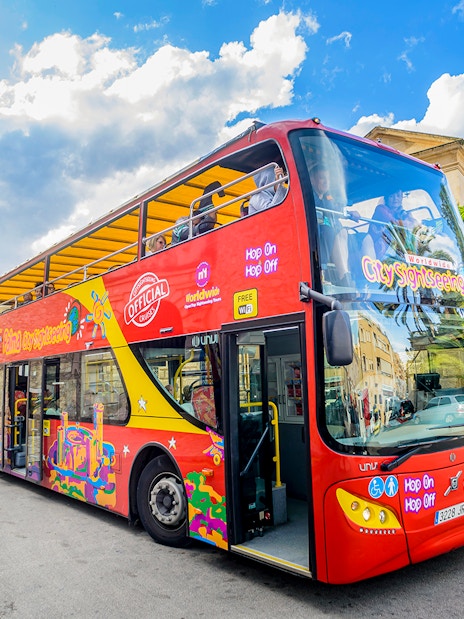 City sightseeing hop-on hop-off bus in front of Pueblo Español, Mallorca.