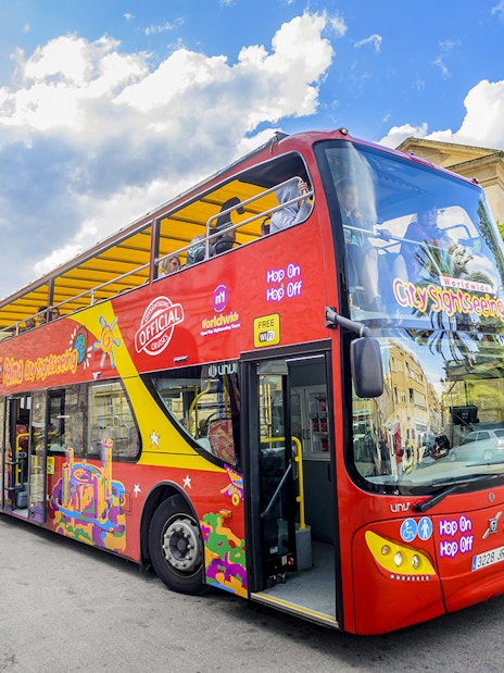 City sightseeing hop-on hop-off bus in front of Pueblo Español, Mallorca.