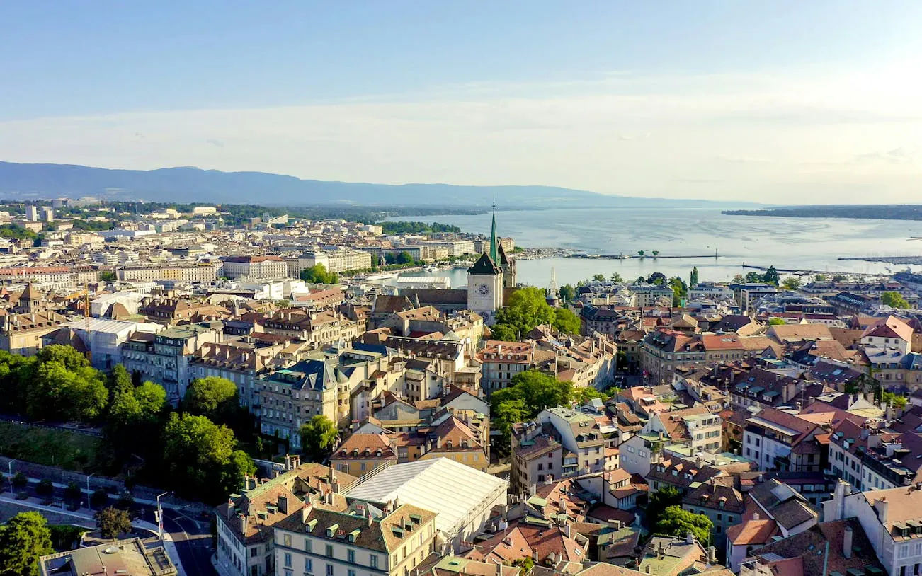 Aerial view of Geneva's old town with St. Peter's Cathedral and Lake Geneva in the background.