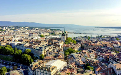 Aerial view of Geneva's old town with St. Peter's Cathedral and Lake Geneva in the background.