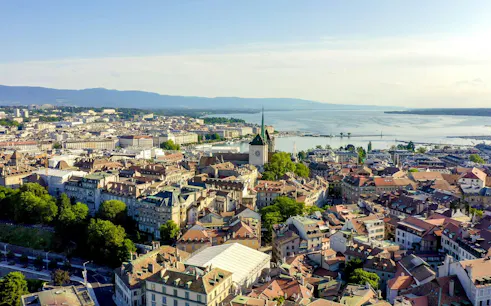 Aerial view of Geneva's old town with St. Peter's Cathedral and Lake Geneva in the background.
