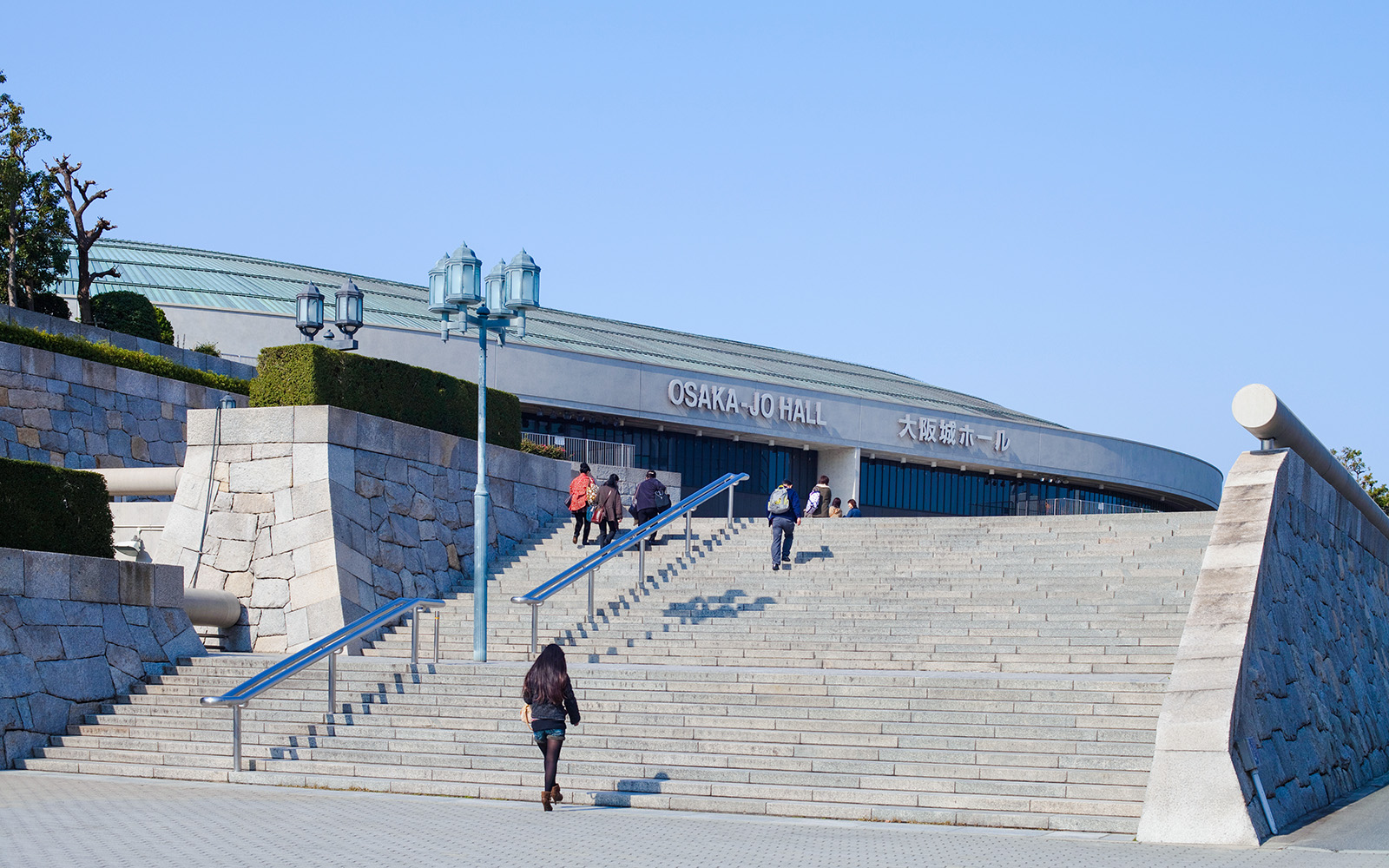 Visitors ascending steps to Osaka JO Hall in Japan.