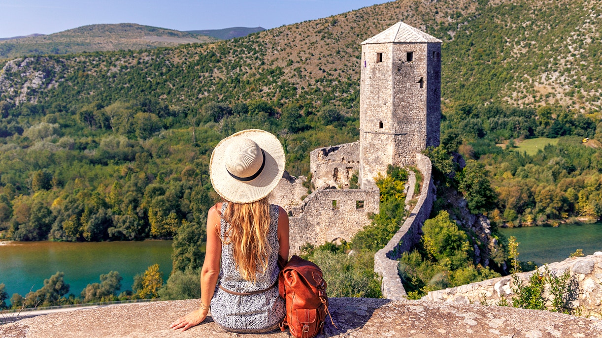 Traveler overlooking historic tower and lush landscape on Mostar guided tour from Split to Trogir.