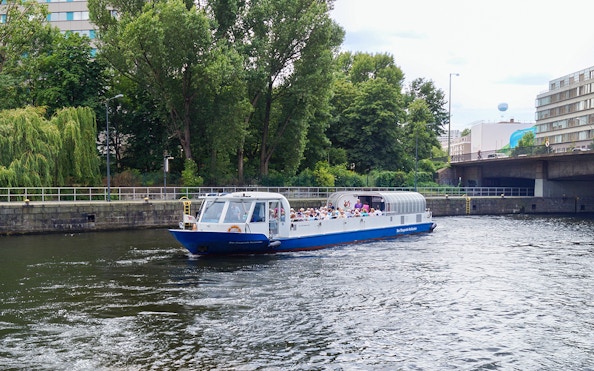 Berlin river cruise boat with passengers enjoying a scenic tour.