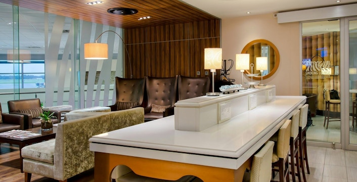 Mashonzha Lounge seating area with chairs and tables at O. R. Tambo International Airport Terminal A, Johannesburg.