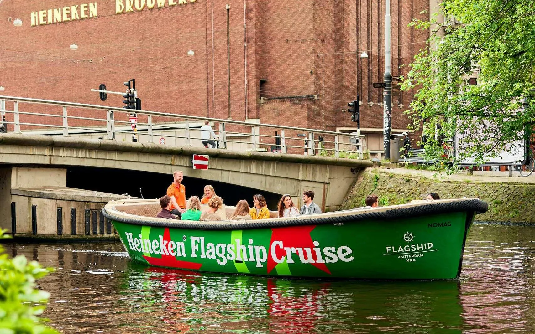 Guests enjoying Heineken Flagship Cruise on Amsterdam canal.
